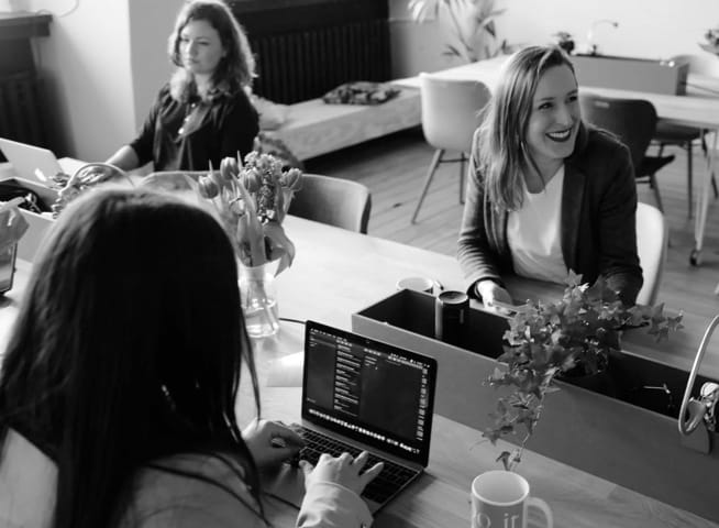 image of three women using a laptop